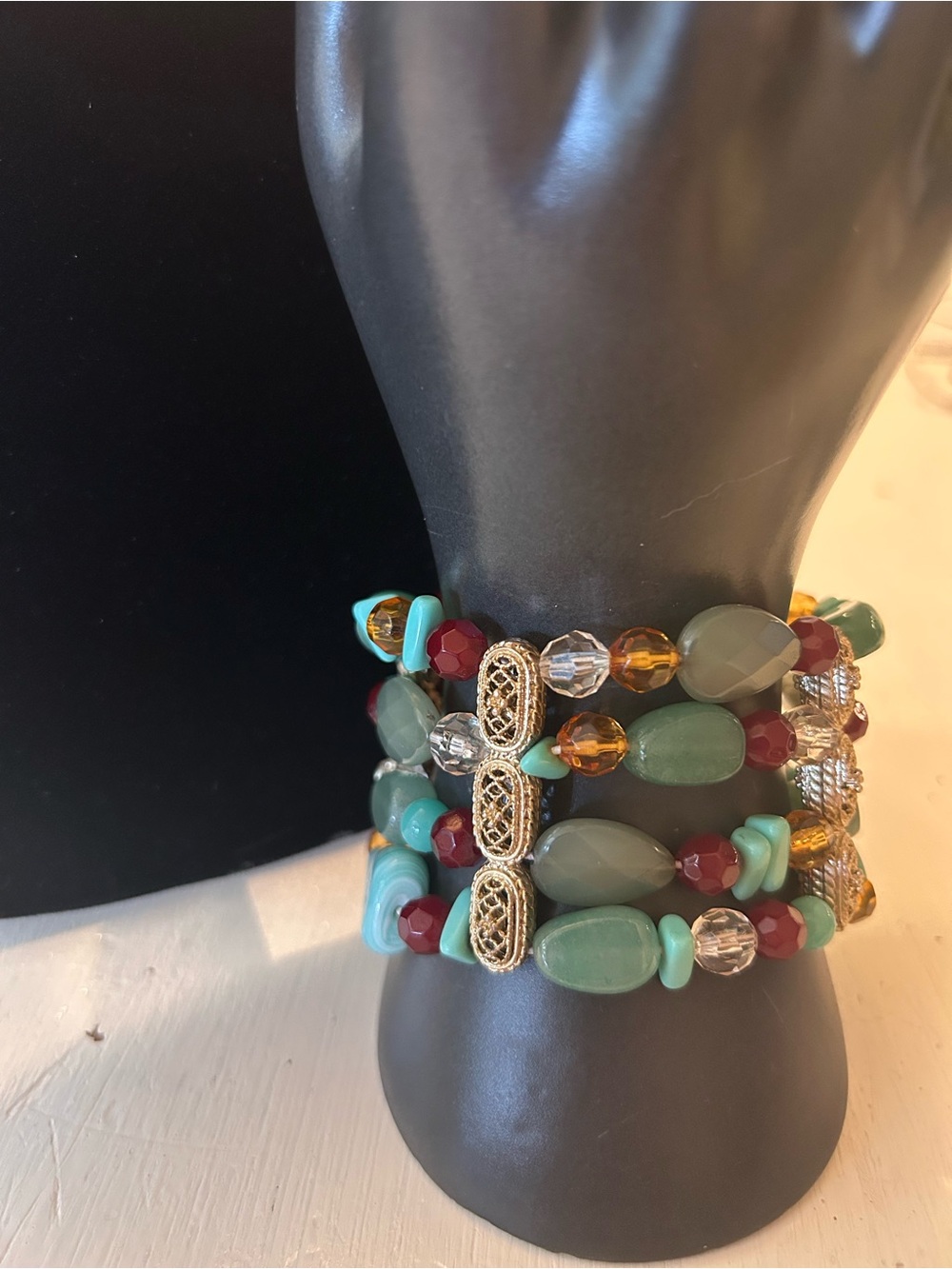Four-strand bracelet,  a mix of green gemstones, clear crystals, and glass beads